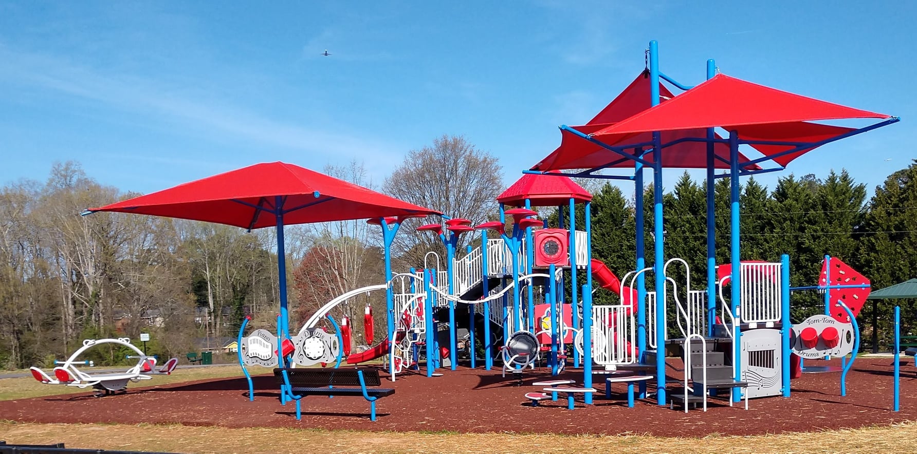 a playground with large red shade covers